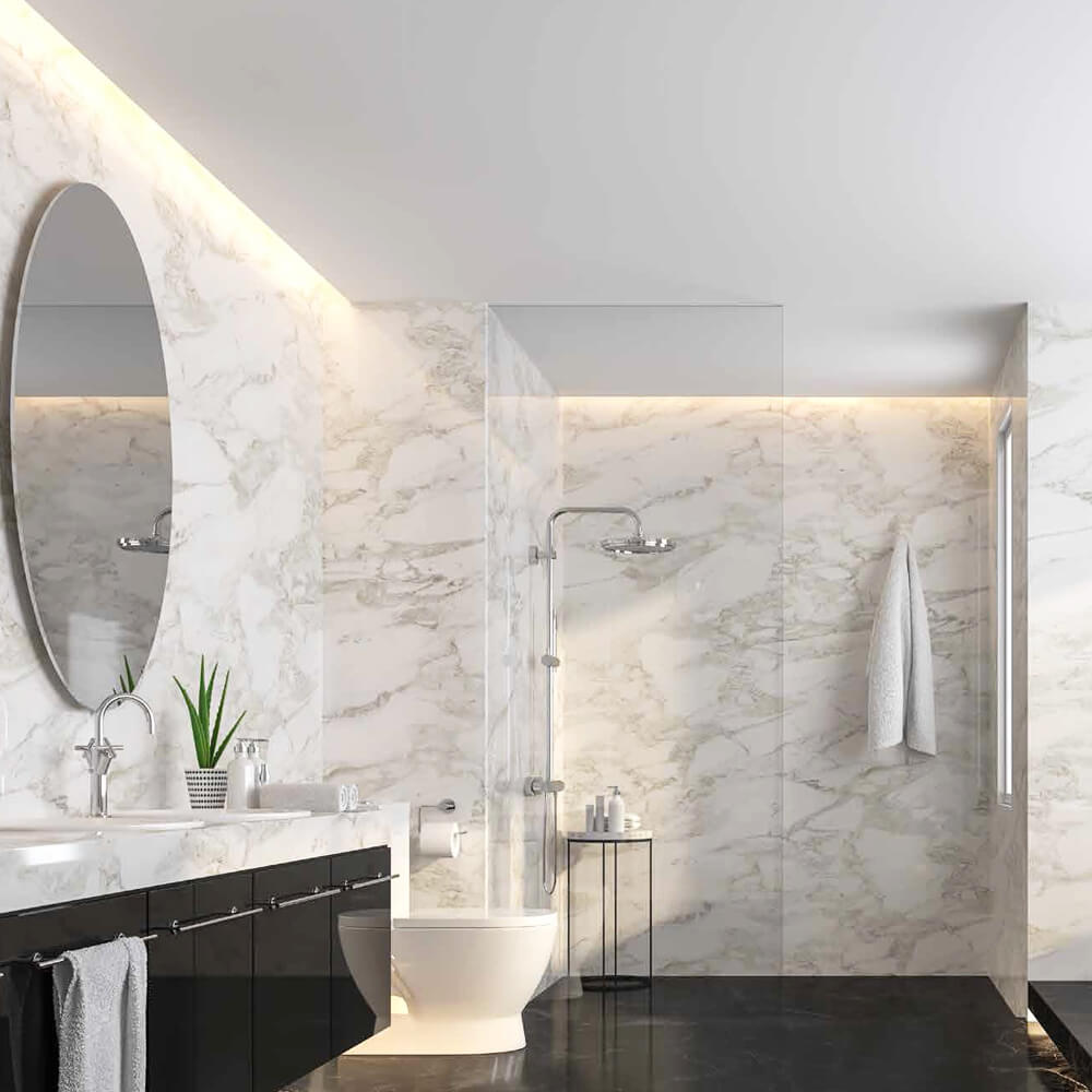 Elegant bathroom design featuring full-height white marble walls with subtle veining, a black vanity, oval mirror, and ambient lighting for a luxurious spa-like atmosphere.