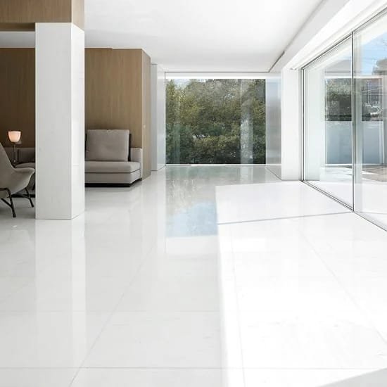 Bright modern interior with large windows and high-gloss white marble flooring, creating a clean and spacious look with natural light flooding the room.