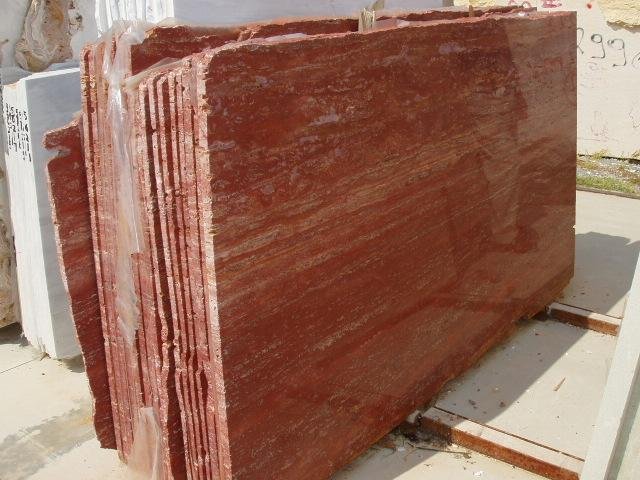 Polished red marble slabs stacked for distribution – premium Rosso Alicante marble by Natural Stone Spain.