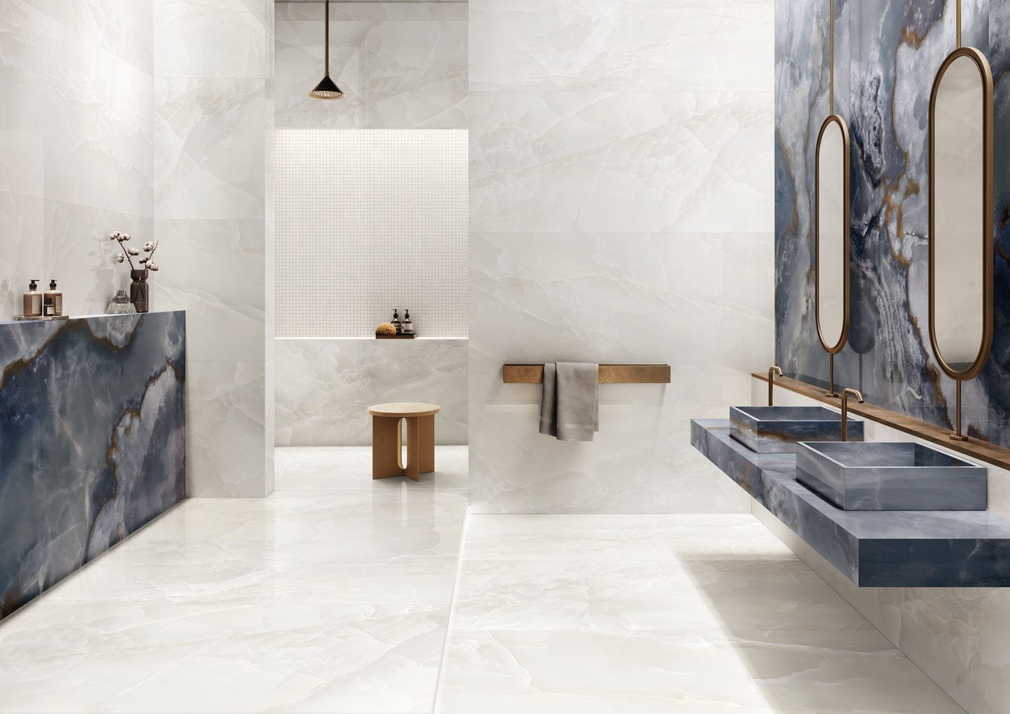 Elegant bathroom interior featuring glossy white marble walls and flooring, contrasted by bold blue marble accents on countertops and décor, creating a luxurious modern ambiance.