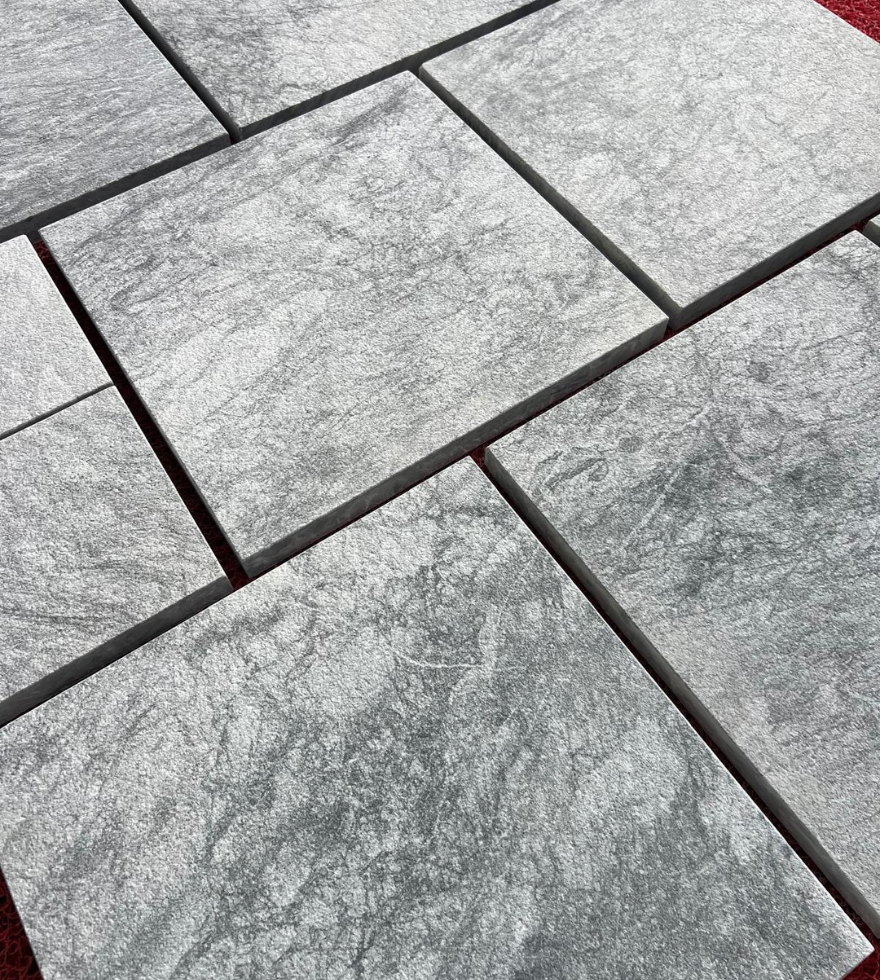 Close-up view of Black Pearl marble pavers in a staggered layout – ideal for outdoor flooring by Natural Stone Spain