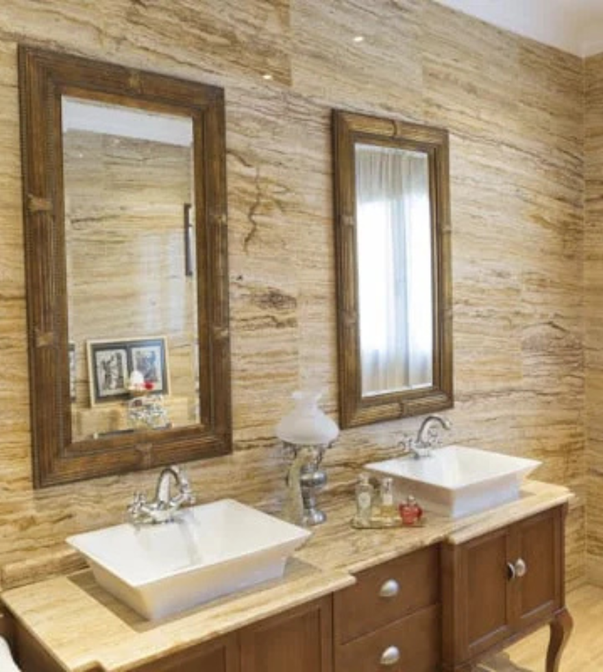 Rustic bathroom with Gold Travertine wall cladding and countertop – warm natural stone elegance by Natural Stone Spain.
