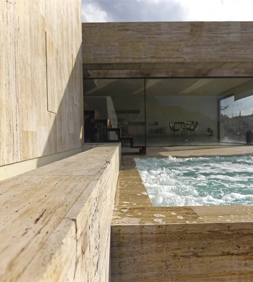 Contemporary outdoor spa area clad in Gold Travertine – luxurious and weather-resistant stone by Natural Stone Spain.