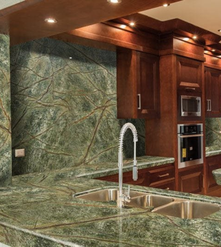 Elegant kitchen interior with Veined Green Forest marble countertops and backsplash – rich earthy tones by Natural Stone Spain.