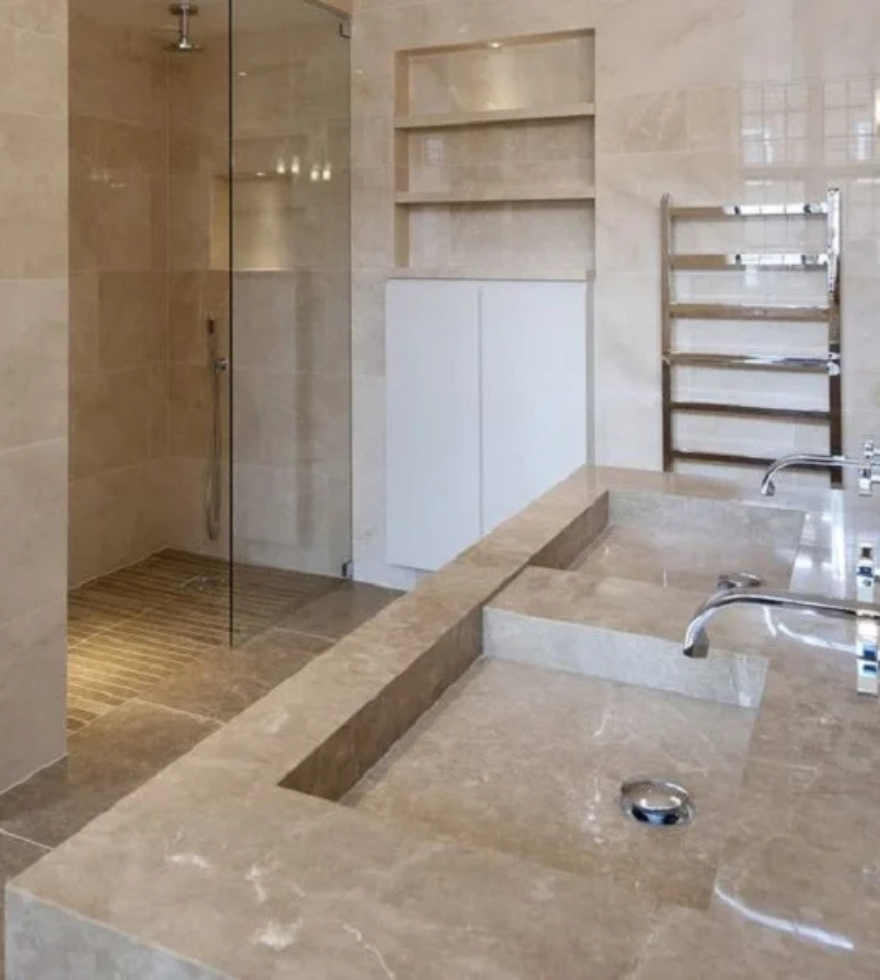 Modern bathroom featuring Light Emperador Marble on walls, countertop, and flooring, highlighting a warm beige tone with a sleek and minimalistic design.