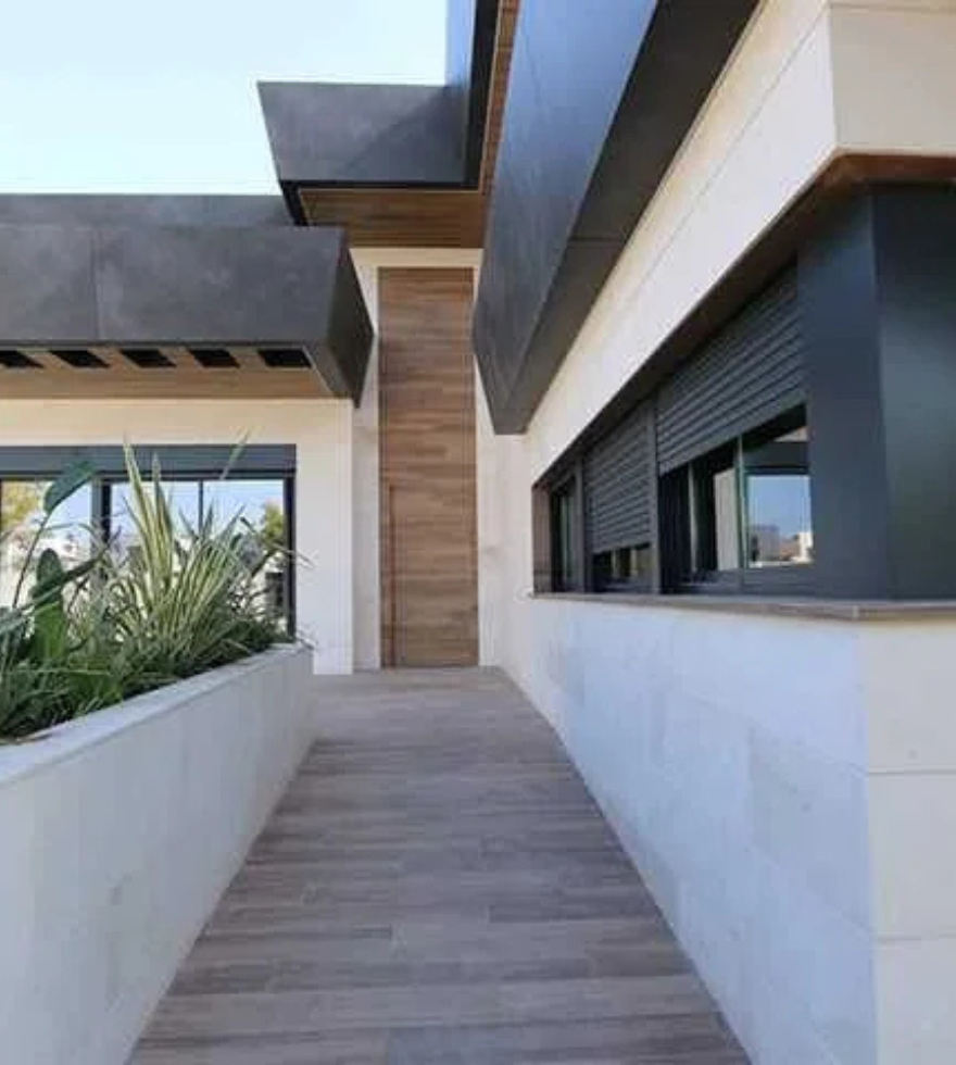 Contemporary home exterior with Caliza Marbella limestone facade and pathway – modern natural stone architecture by Natural Stone Spain.