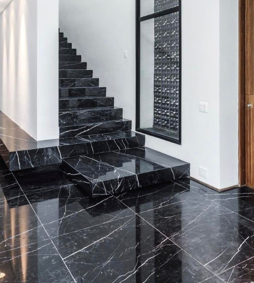 Contemporary staircase and flooring in polished Negro Marquina marble – striking black stone with white veining by Natural Stone Spain.