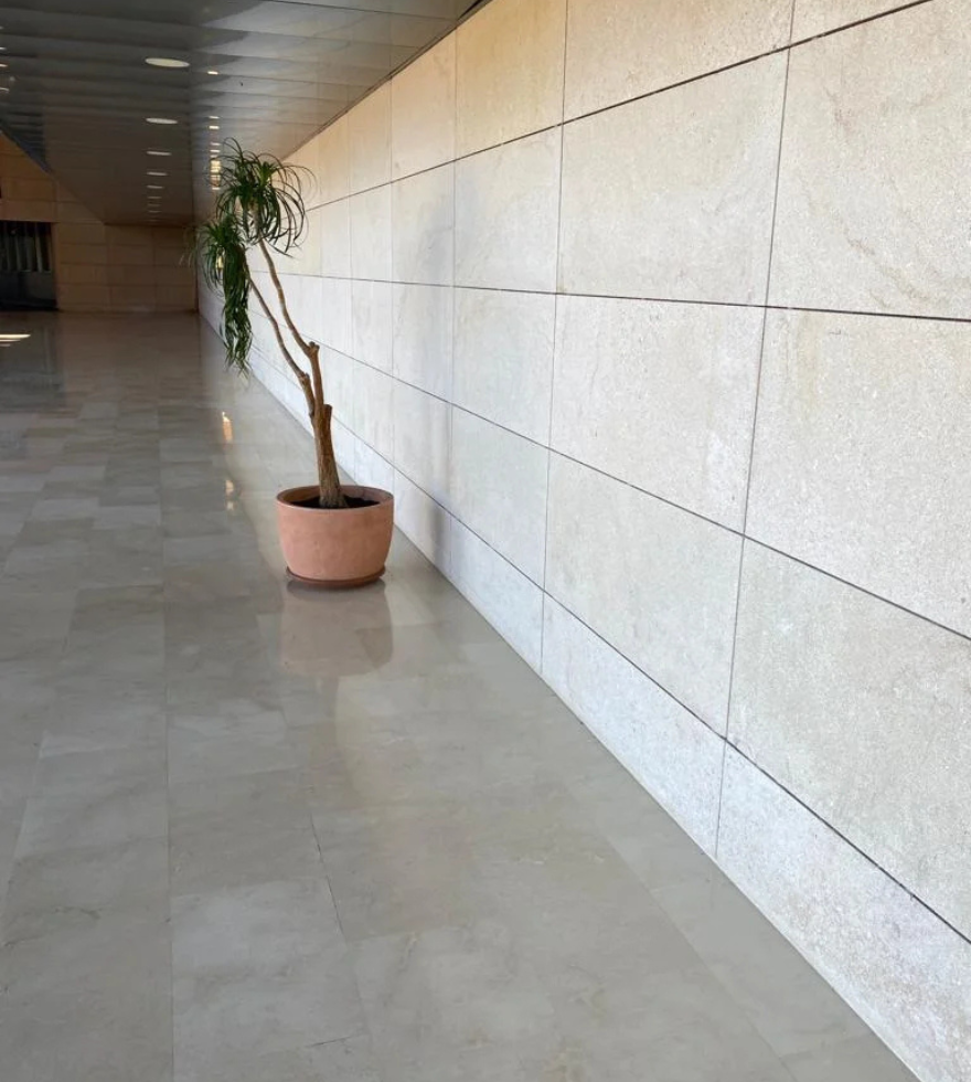 Modern corridor with limestone wall cladding and polished flooring – minimalist natural stone design by Natural Stone Spain.